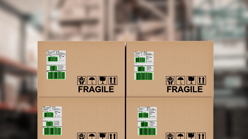 Boxes with barcode labels in a warehouse. The barcodes show green overlays as they have been scanned with the Viziotix barcode scanner SDK. Experts in barcode scanning. Viziotix barcode reader SDK. Viziotix barcode decoder SDK.