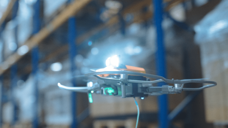 Barcode Scanner for Inventory in the Warehouse. The image shows a drone scanning barcodes in a warehouse.