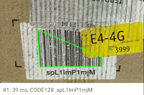 A close up of a label on cardboard parcel that is very dirty and damaged. The barcode is still scanned by the Viziotix Barcode SDK for automation barcode scanning.