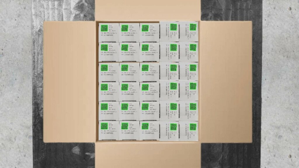 Medical items packs in a box on a palett. The box is open and many Data Matrix codes are visible. These are highlighted in green to show they have been scanned by the Viziotix barcode scanner SDK.